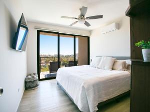 a bedroom with a bed and a ceiling fan at Sea Esta - Terra 194 in Cabo San Lucas +38 photos