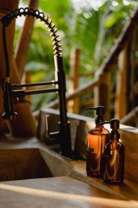 dos botellas de jabón están sentadas junto a un fregadero en Bamboo Tree House romantic & luxury retreat, en Brisas de Zicatela