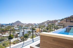 a view from the balcony of a house with a swimming pool at Sea Esta - Terra 194 in Cabo San Lucas