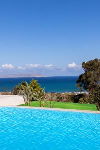 a swimming pool with a view of the ocean at Luxury Villa U in Kokkini Khanion