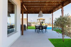 a patio with a table and chairs on it at Luxury Villa U in Kokkini Khanion
