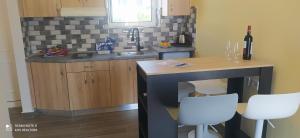 a kitchen with a table and white chairs at Giovanni Apartment 21 Kos in Kos Town