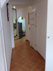 a hallway with a tile floor and an open door at Mieszkanie Jadwigi in Giżycko