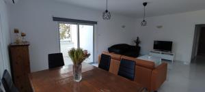 a living room with a wooden table and a couch at Ellas Modern Duplex City Center in Nicosia