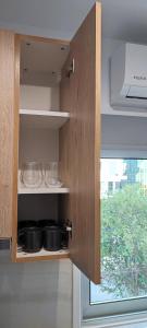 a kitchen with some pots and pans on a shelf at Ellas Modern Duplex City Center in Nicosia