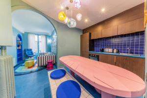a kitchen with a pink table and blue chairs at Emblematic apartment 2BR6P Saint honoré Rivoli in Paris