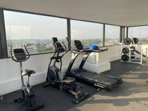 a gym with two exercise bikes and a desk at 1 Bedroom Luxury Furnished Apartment in East Legon in Accra