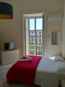 a bedroom with a bed and a large window at La Casa di Elvira in Naples