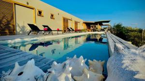 a swimming pool with snow figures next to a house at Caribbean Oceanview Villa in Kralendijk