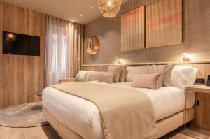 a bedroom with a large white bed with pink pillows at The Valentia Corretgería in Valencia
