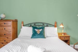 エディンバラにあるBright and Quiet Edinburgh Homeのベッドルーム1室(ベッド1台、枕、蜂付)