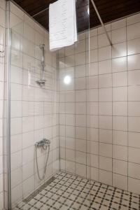 a bathroom with a shower and a tiled floor at Historic Greek Pavillion Golden Horn Istanbul in Istanbul