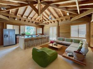 a living room with a couch and a kitchen at Caribbean Oceanview Villa in Kralendijk