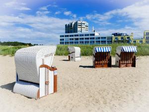 a group of chairs sitting on the beach at Am Sahlenburger Strand AS23 in Cuxhaven