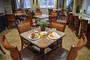 a restaurant with tables and chairs with food on them at Stonebrook Lodge in Cherokee