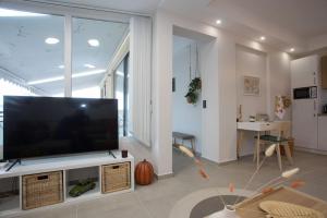 a living room with a large flat screen tv at Cozzzy. Exclusive Apartment. in Thessaloniki