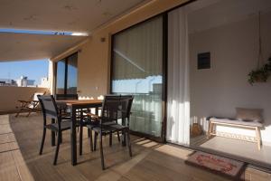 jadalnia ze stołem i krzesłami na balkonie w obiekcie Cozzzy. Exclusive Apartment. w Salonikach