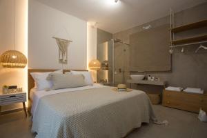 a bedroom with a large bed and a bathroom at Cozzzy. Exclusive Apartment. in Thessaloniki