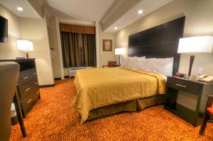 a hotel room with a bed and a desk at Stonebrook Lodge in Cherokee