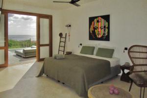 a bedroom with a bed and a view of the ocean at Caribbean Oceanview Villa in Kralendijk +16 photos