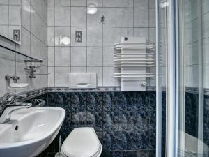 a bathroom with a toilet and a sink at Pokoje Gościnne Zbyszko in Zakopane +16 photos