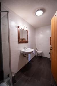 a bathroom with a sink and a toilet at Haus Raggl in Landeck