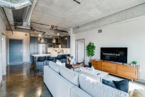 a living room with a couch and a tv at Sable 75 - Two Bedroom in Minneapolis