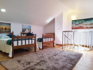 a bedroom with two beds and a rug at MCStylo-Ocean View in Caniço