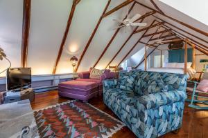 a living room with a couch and a tv at Beautiful Historic 4-Season Country Estate in Okemo Valley in Cavendish