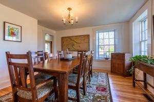 a dining room with a wooden table and chairs at Beautiful Historic 4-Season Country Estate in Okemo Valley in Cavendish