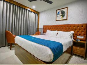 a bedroom with a large bed and a window at RONTA WORLD HOTELS in Chandīgarh