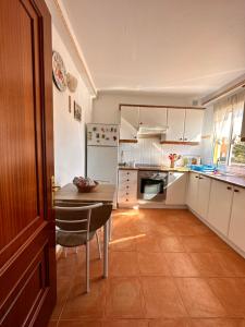 a kitchen with a table and a dining room at La Casita in Costa de Antigua