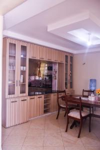 a kitchen with a wooden table and a dining room at Serenity Home in Lake View Estate