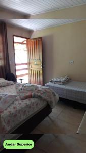 Säng eller sängar i ett rum på Hospedaria Recanto dos Pássaros