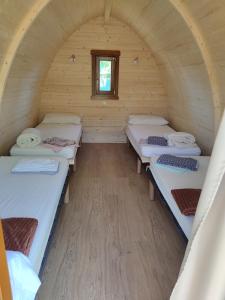 a room with three beds and a window at TEIRABOA BASE CAMP in Arzúa