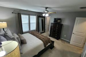 a bedroom with a bed and a ceiling fan at Mackintosh Townhome in Burlington