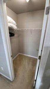 a room with a closet with a door open to a bathroom at Mackintosh Townhome in Burlington