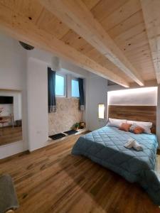 a bedroom with a large bed and a wooden floor at Core Cagliari in Cagliari