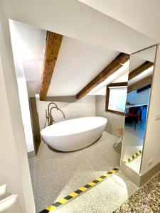 a bathroom with a large white tub in a room at TRA SAN MARCO E RIALTO in Venice