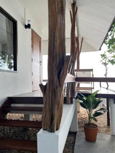una scultura di tronchi d'albero seduta su una scala in una casa di Boon Heritage House Koh Samui a Ko Samui