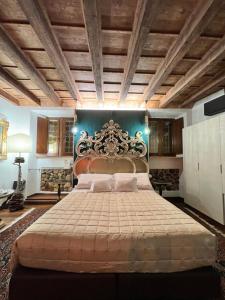 a bedroom with a large bed with a wooden ceiling at Marcello Sleep&Spa in Verona