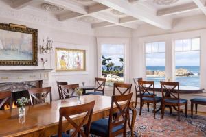a dining room with a table and chairs and the ocean at Seven Gables Inn on Monterey Bay, A Kirkwood Collection Hotel in Pacific Grove