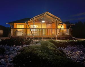 a house with a lit up porch at night at Kuanza Farmhouse and Lodge in Zambujeira do Mar