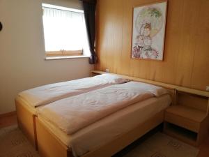 a small bed in a room with a window at LA CESURA in Carano
