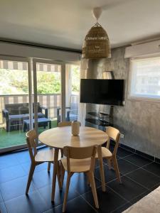 a kitchen with a table and chairs and a dining room at Charmant 2 pièces proche Monaco - Parking privé in Menton