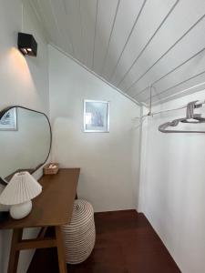 a dressing room with a mirror and a table at Boon Heritage House Koh Samui in Koh Samui 