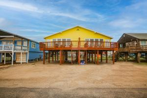 a house with a deck on a beach at Amazing Oceanfront 2BR Home Cozy Peaceful and Kid and Pet Friendly in Freeport