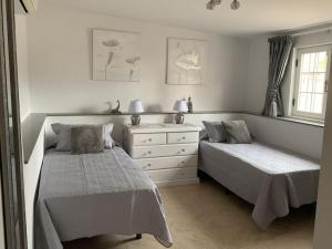 a bedroom with two beds and a dresser at Casa Paraiso Villa Tenerife, stunning family bungalow with totally secluded pool area, wheelchair friendly in San Miguel de Abona +17 photos