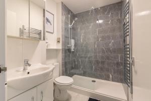 a bathroom with a sink and a toilet and a shower at Racecourse Revelation! Free parking in Newbury