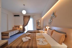 Postel nebo postele na pokoji v ubytování Aigli Rooms + 37 fotografií